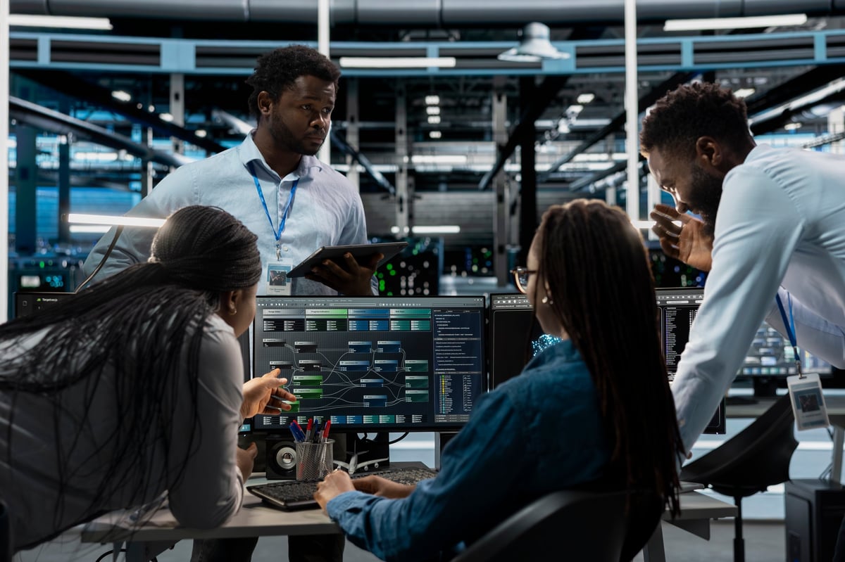 System administrators programming in AI data center housing advanced equipment