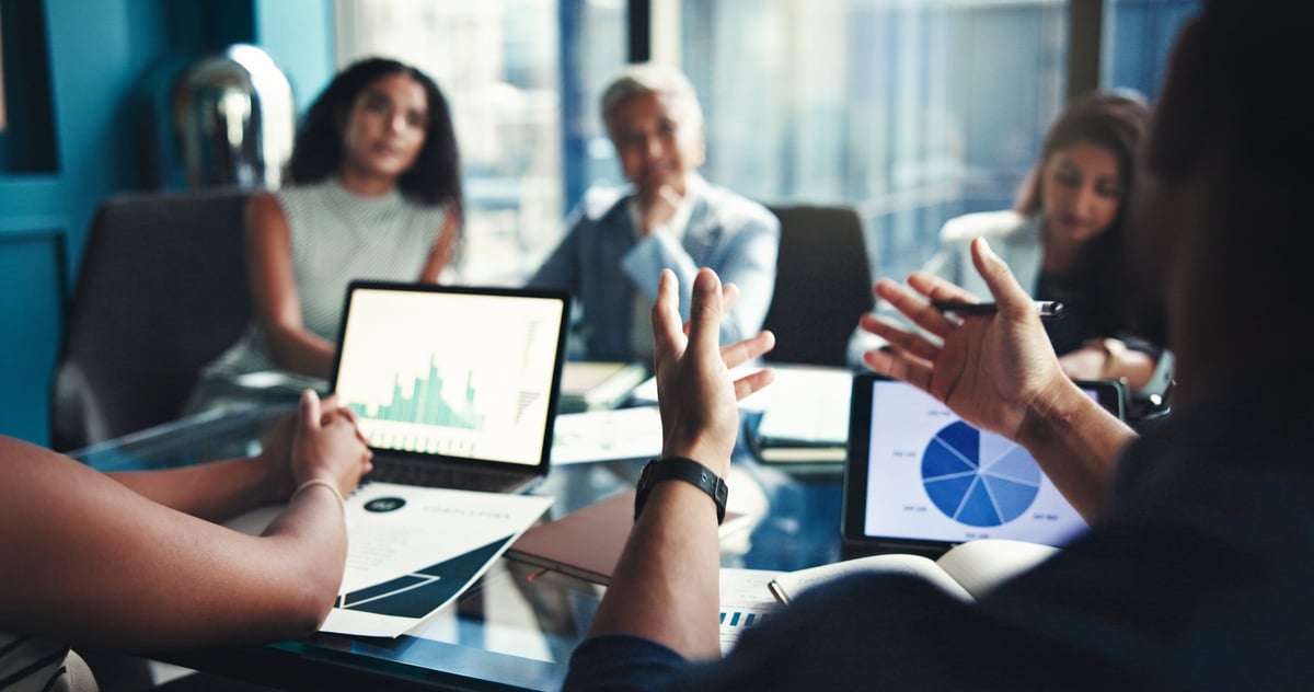 Finance team in office boardroom reviewing investment opportunities and business growth strategy