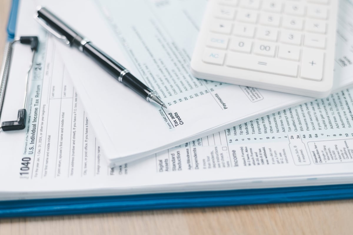 US individual income tax return form with pen and calculator